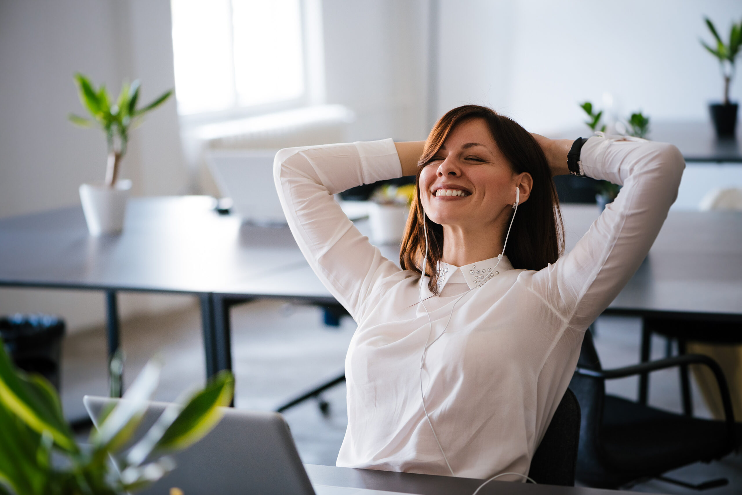 woman in an office relaxing and smiling