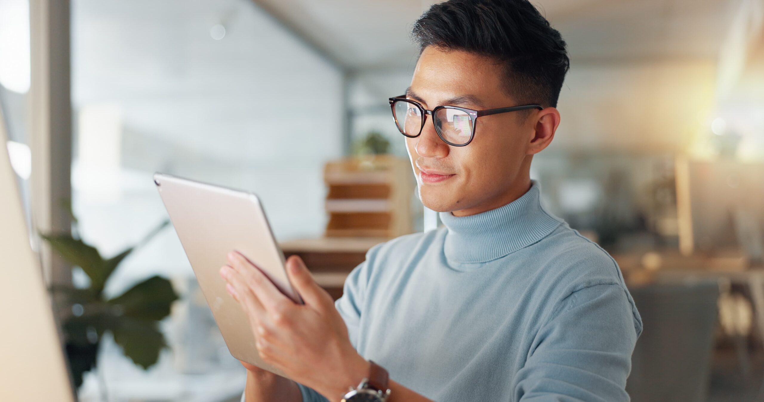 guy with glasses reading from a kindle