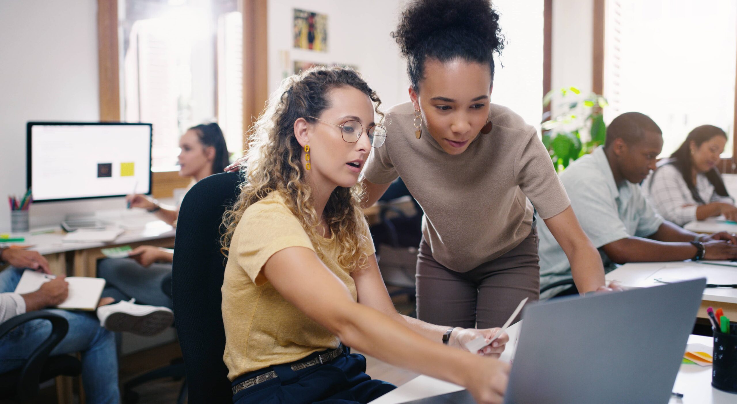 two girls at work checkind data 