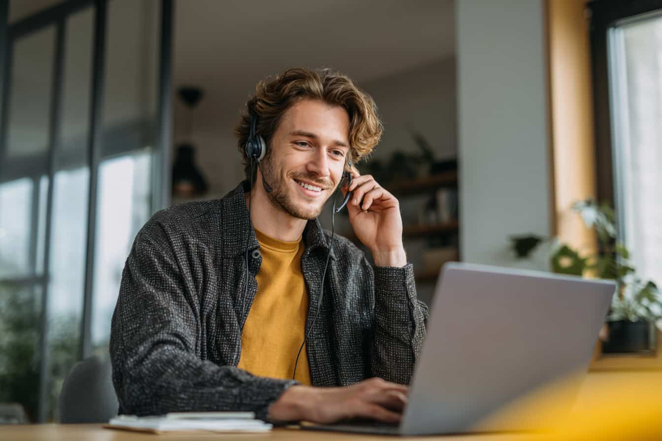 young man wearing headphones with mic conducting a market research interview